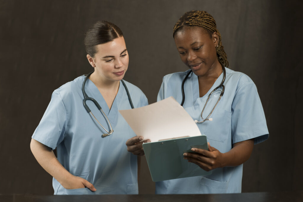 two female nurses working clinic scrubs